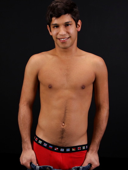 Carmine posing naked in a bedroom